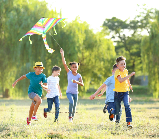 children in nature flying kites and running in Castle Rock open spaces to represent activities that promote emotional regulation and emotional wellbeing